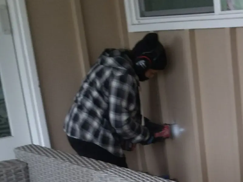 Professional electrician installing an exterior outlet in Duluth
