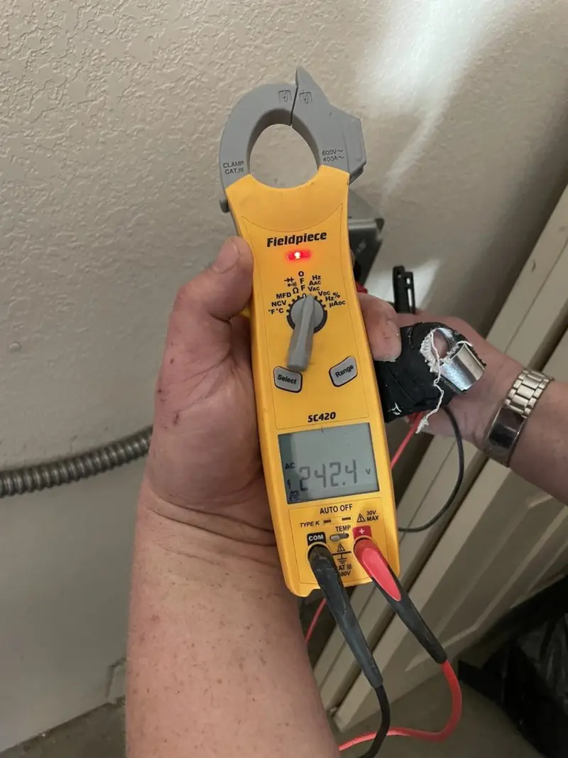 Voltage testing with clamp meter during Recessed Lighting Installation in Duluth